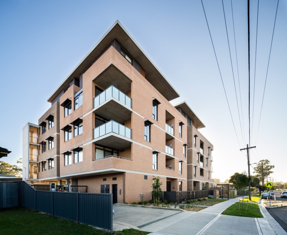 Five story apartment building shown from the street