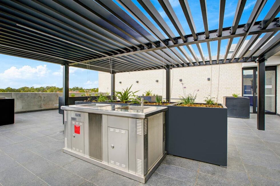 Rooftop barbecue, garden and community space, with a view over the suburbs