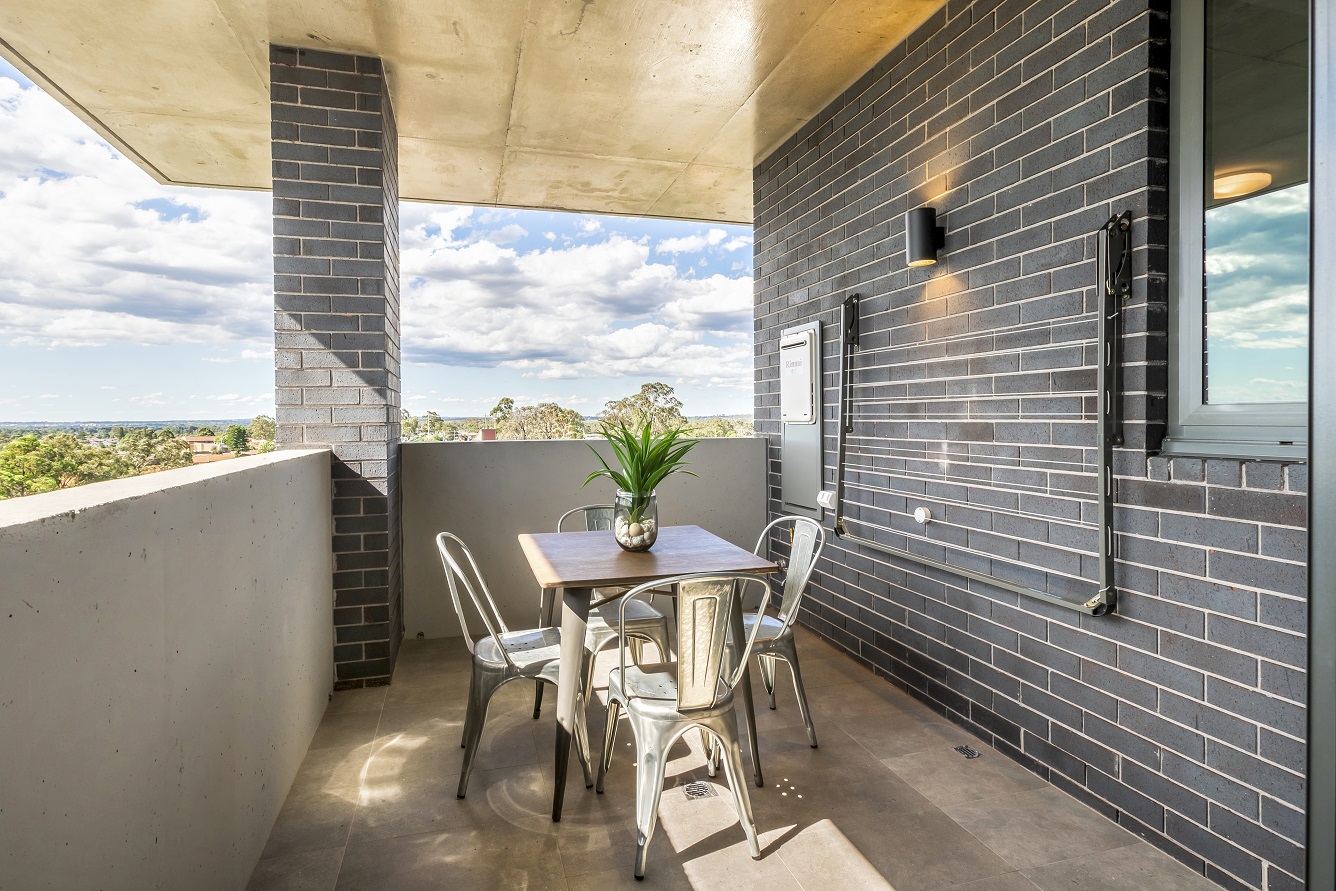 View from a balcony on a sunny day, with an outdoor table