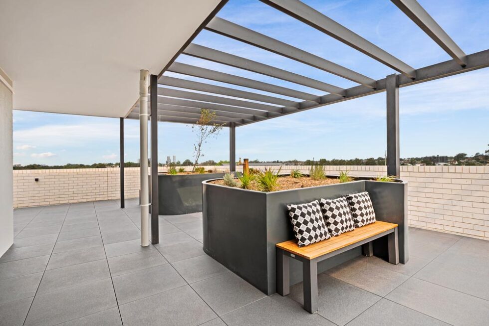 Rooftop garden and community space with a view over the suburbs