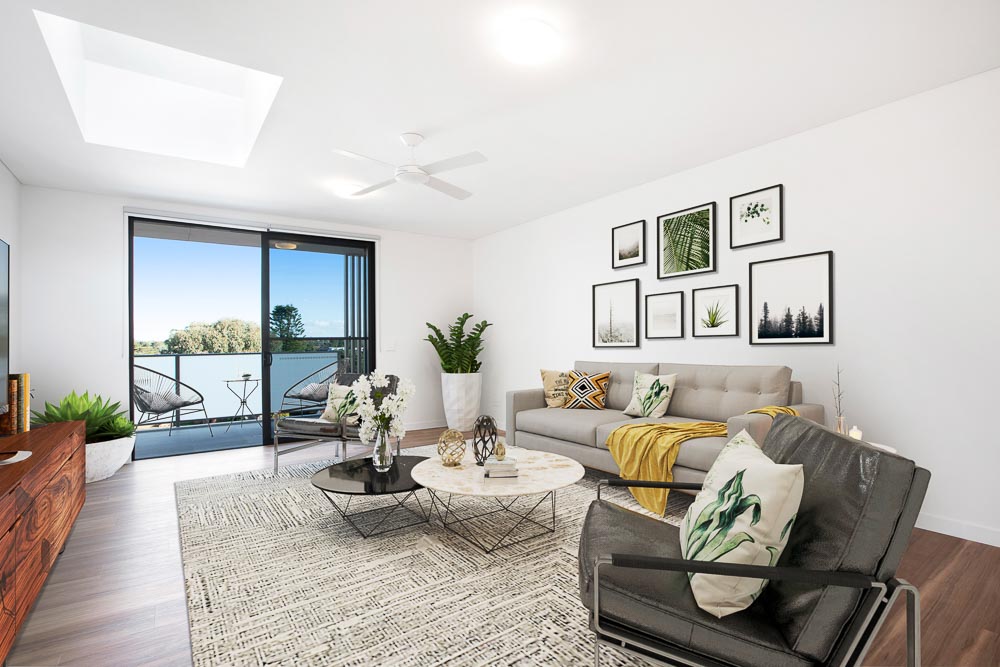 Lounge area of a unit with display furnishing, large couch, entertainment unit and coffee table