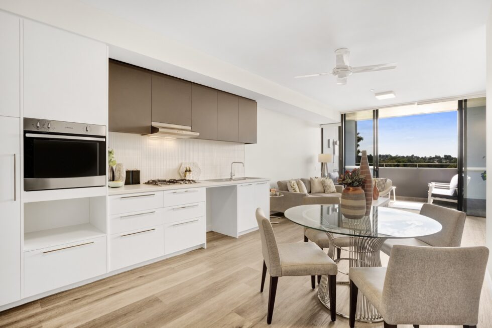 Kitchen dining area of display furnished unit, looking through to balcony