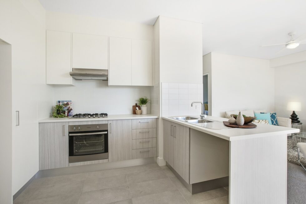 Kitchen overlooking lounge area in display furnished unit