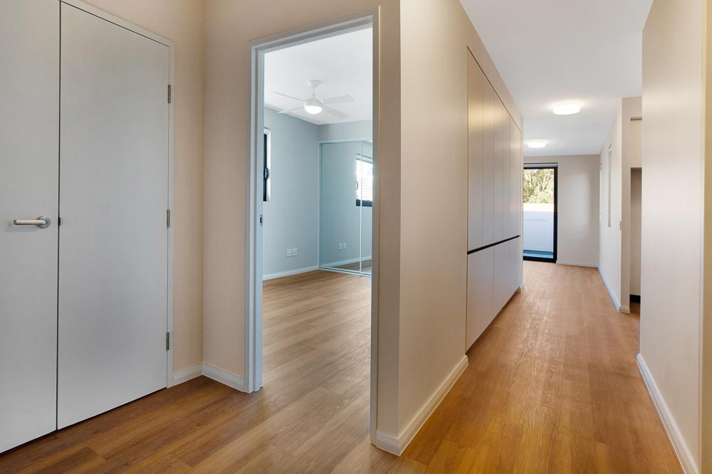 View of hallway and bedroom in unfurnished unit