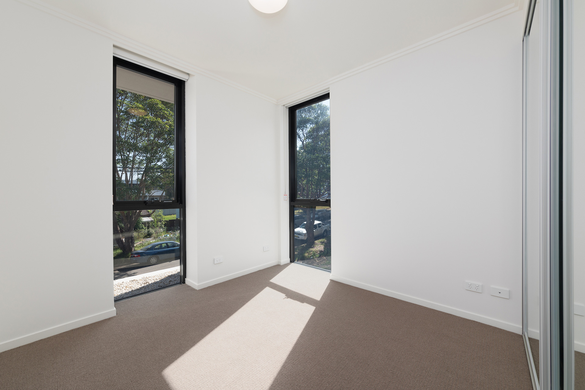 Bedroom of unfurnished unit with a view over the street