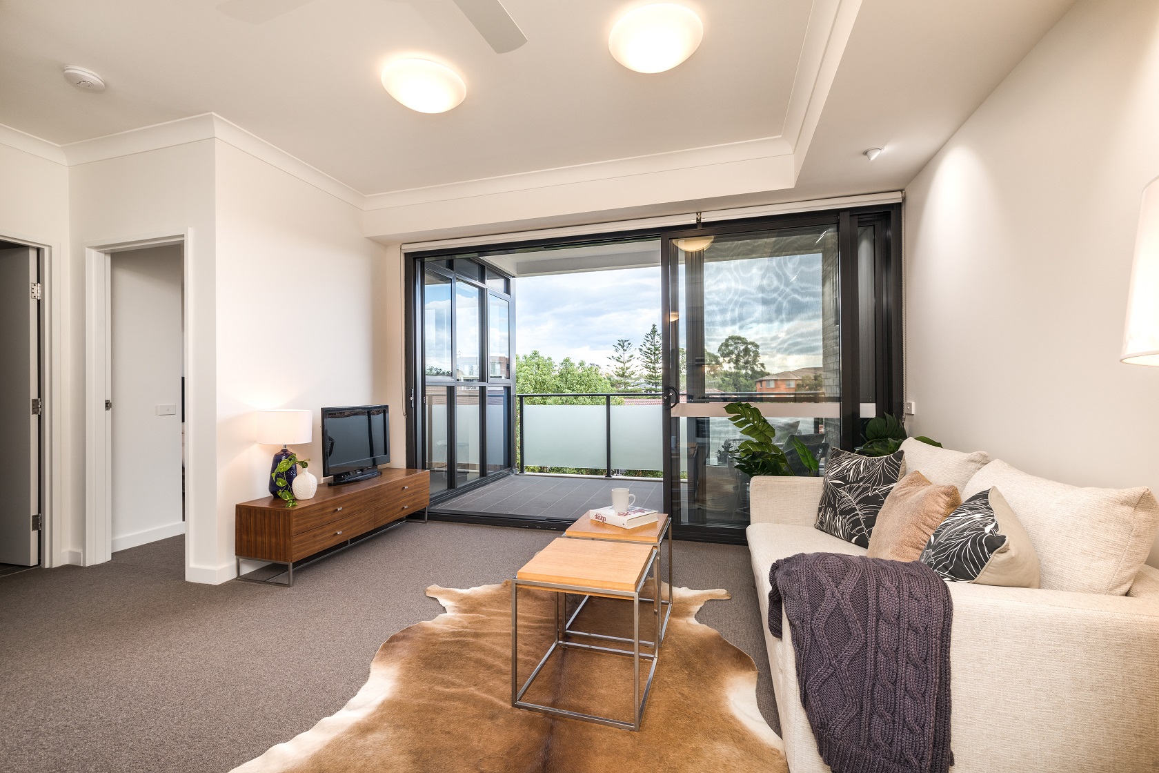 View from loungeroom through to balcony of spacious display furnished unit