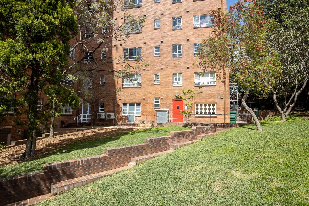 Green lawn outside a multi story building