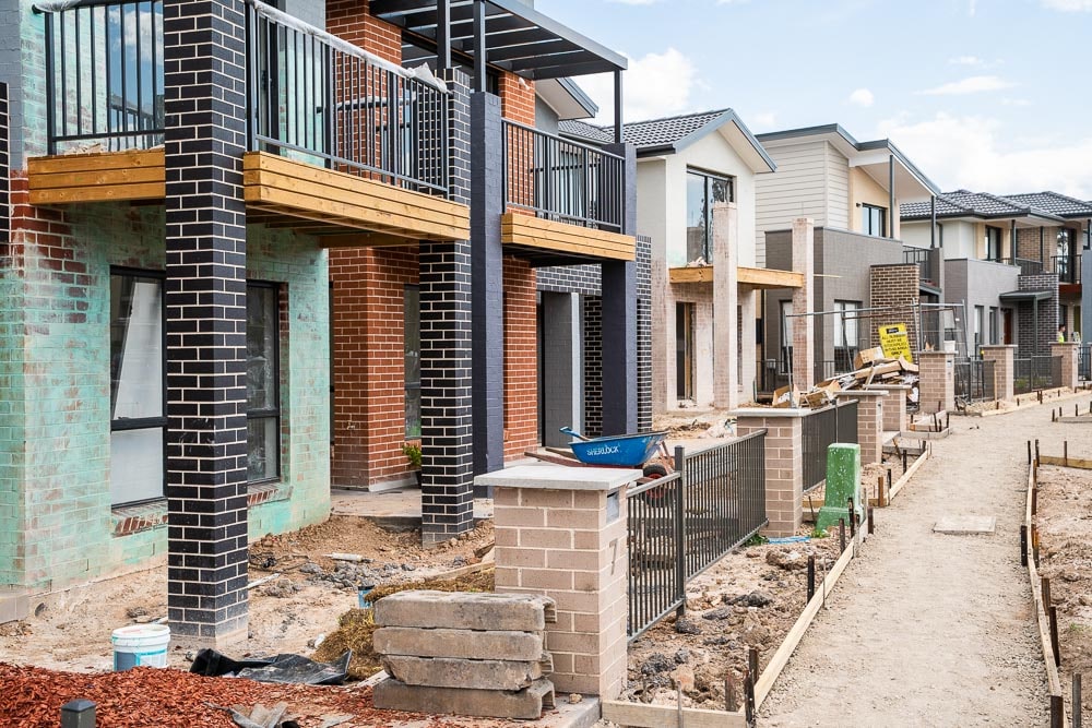 A row of two story homes under construction