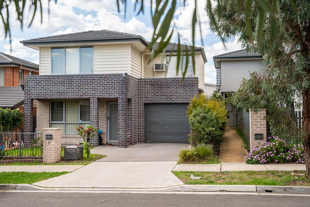 Two story home in Bonnyrigg with trees and lush gardens