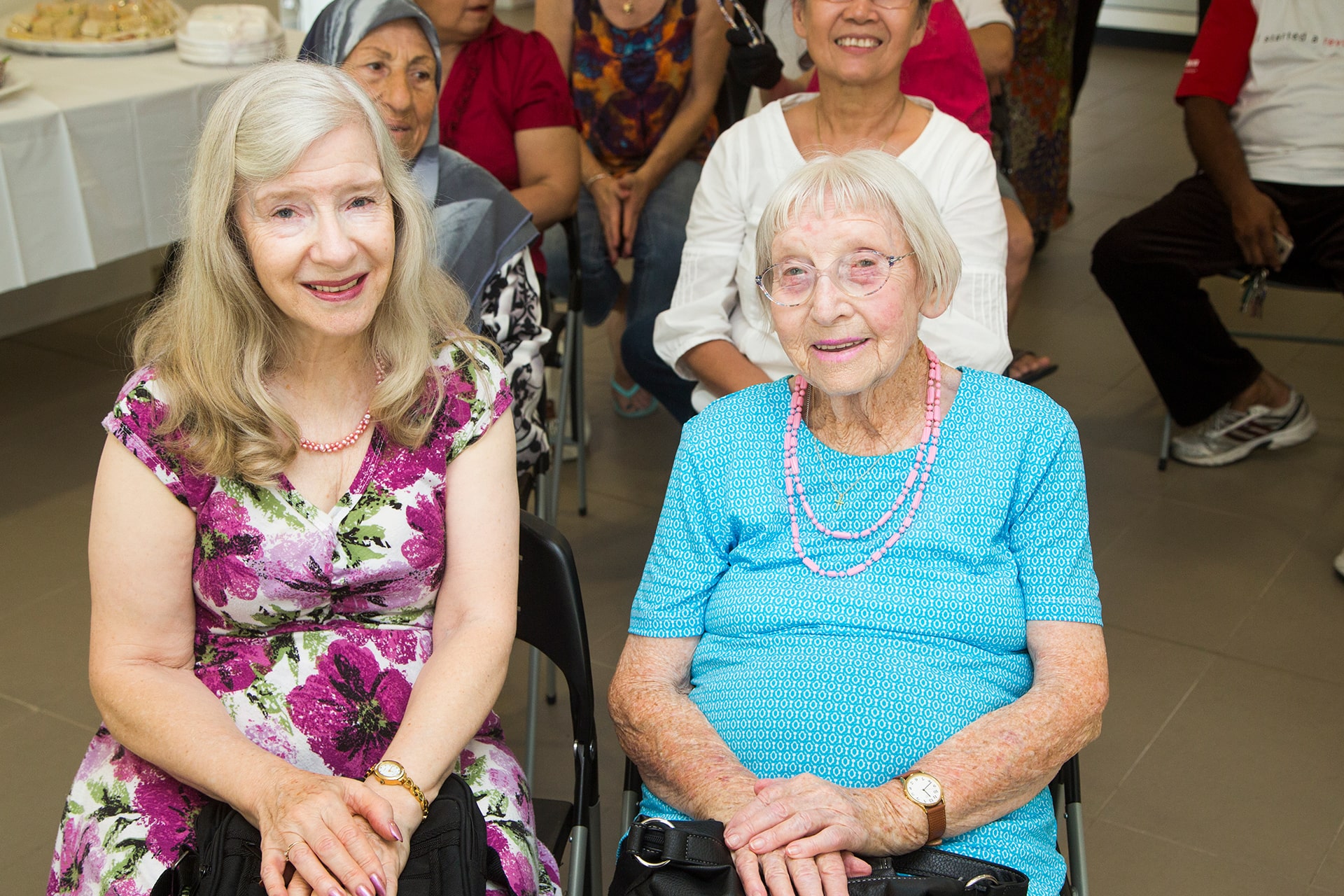 Smiling customers seated in the audience at a presentation