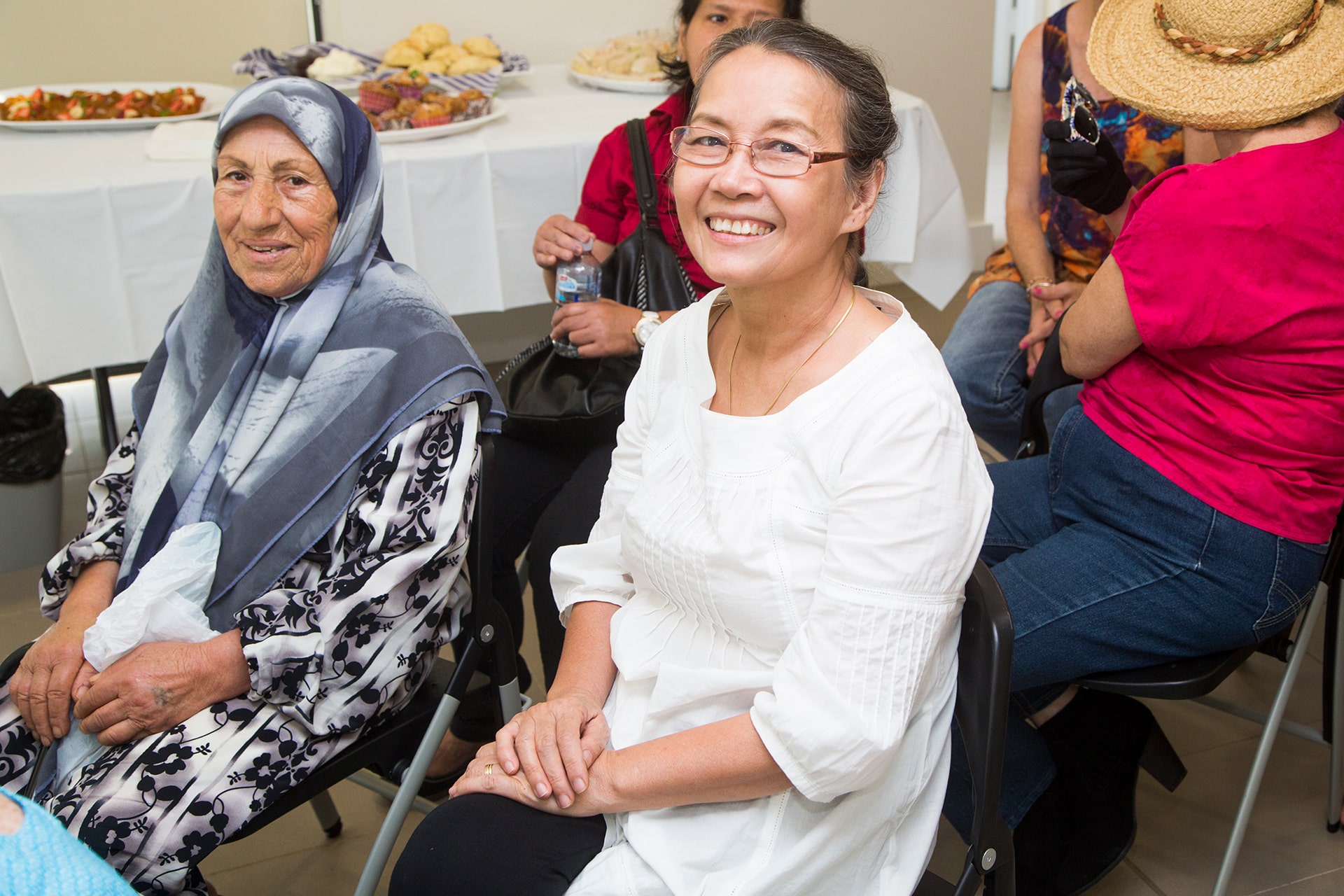 Smiling customers seated in the audience at a presentation