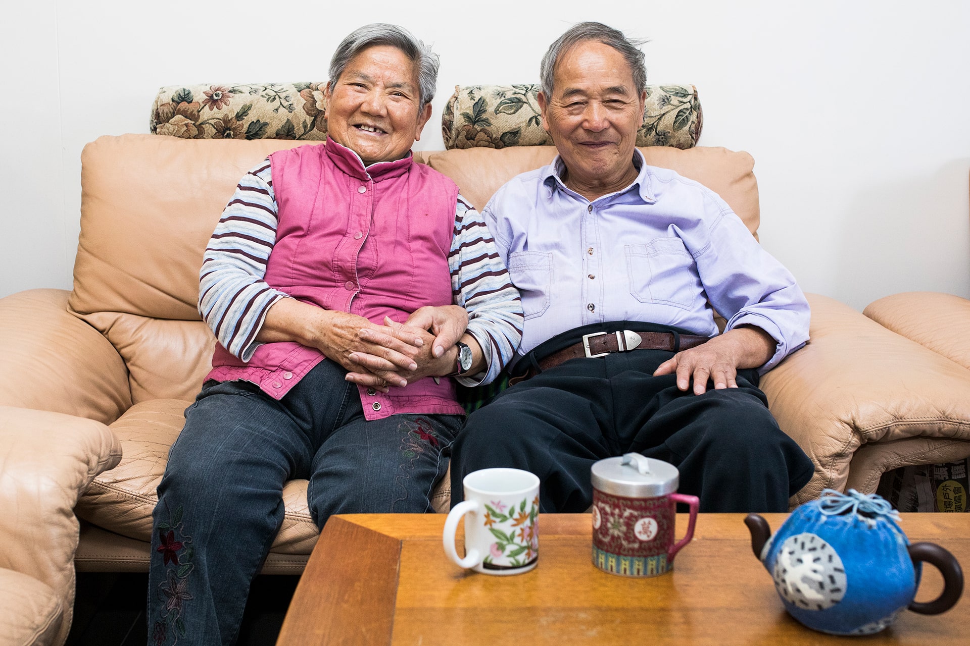 Smiling senior couple sitting on a couch