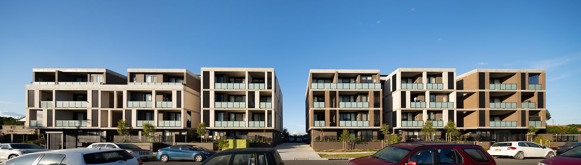 Two wide, four story buildings separated by a driveway