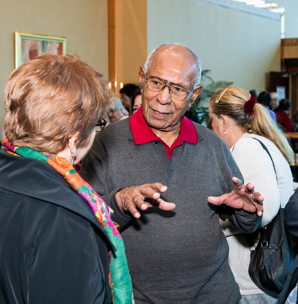 Two people having a conversation in a crowded room