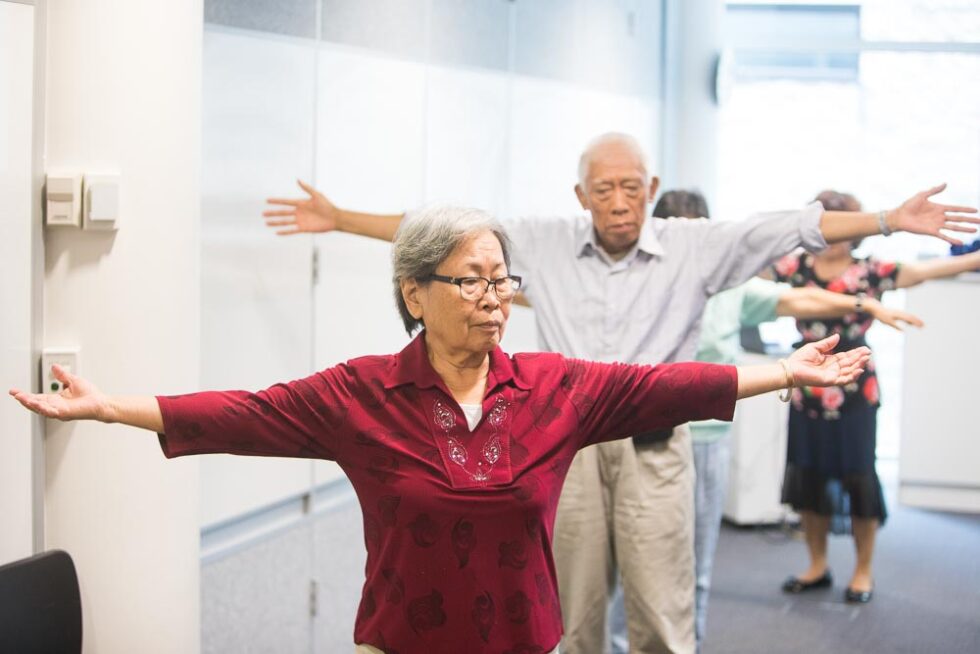 Senior customers doing gentle exercise indoors