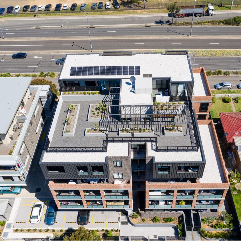 Drone photo of a five storey building with rooftop garden