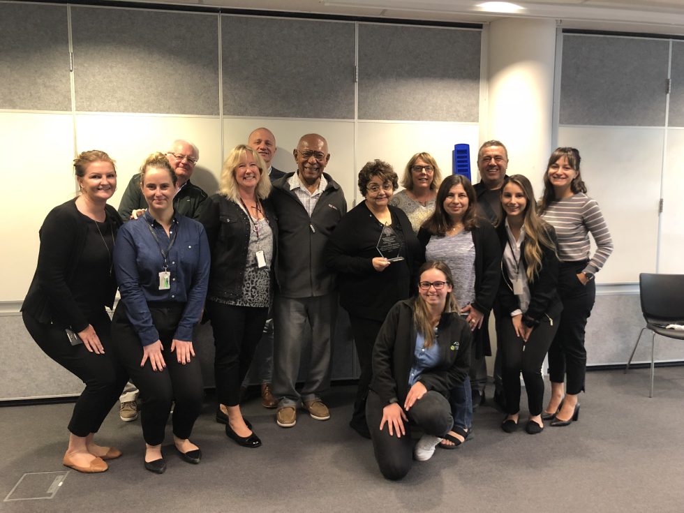 A smiling group shot of the tenant coordination panel team members