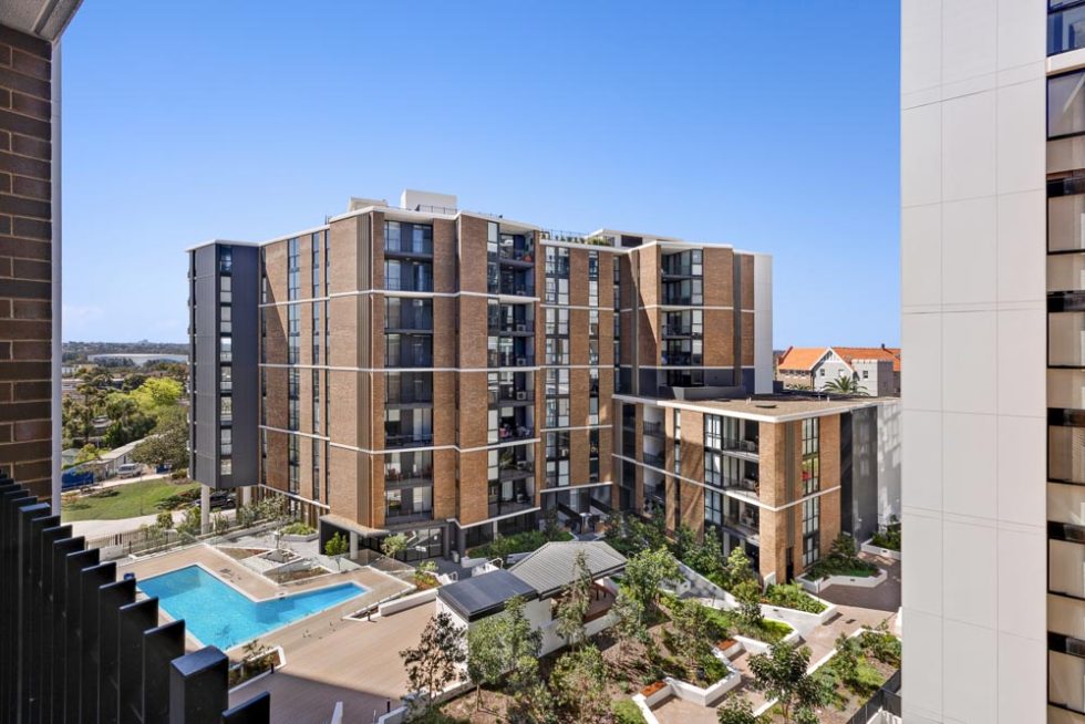 View from a balcony over a unit complex and pool