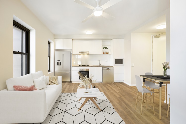 The lounge area and kitchenette of a modern furnished unit