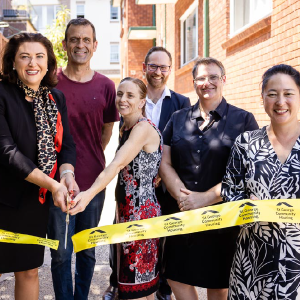 Natasha Maclaren-Jones, CEO Scott Langford and Jenny Leong MP with three SGCH customers cut the ribbon at Palace St Petersham