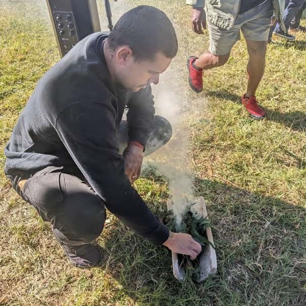 A young man performing a smoking ceremony